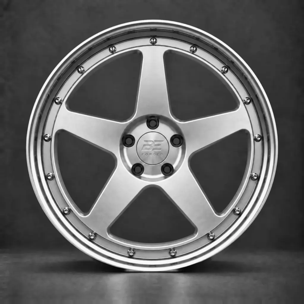 BE FORGED five-spoke multi-piece wheel with alternating exposed and hidden 50/50 hardware, brushed silver face and polished step lip.