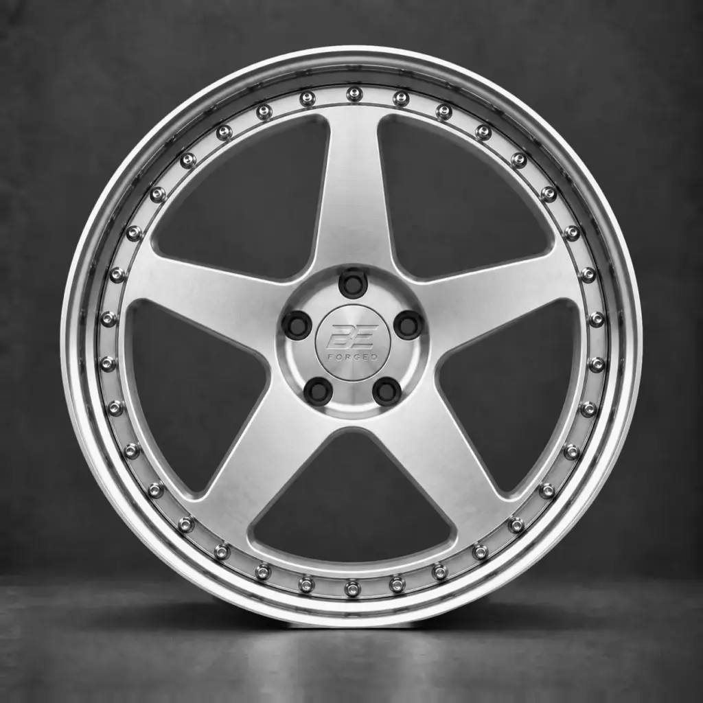 BE FORGED five-spoke multi-piece wheel with full exposed perimeter hardware, brushed silver face and polished step lip.